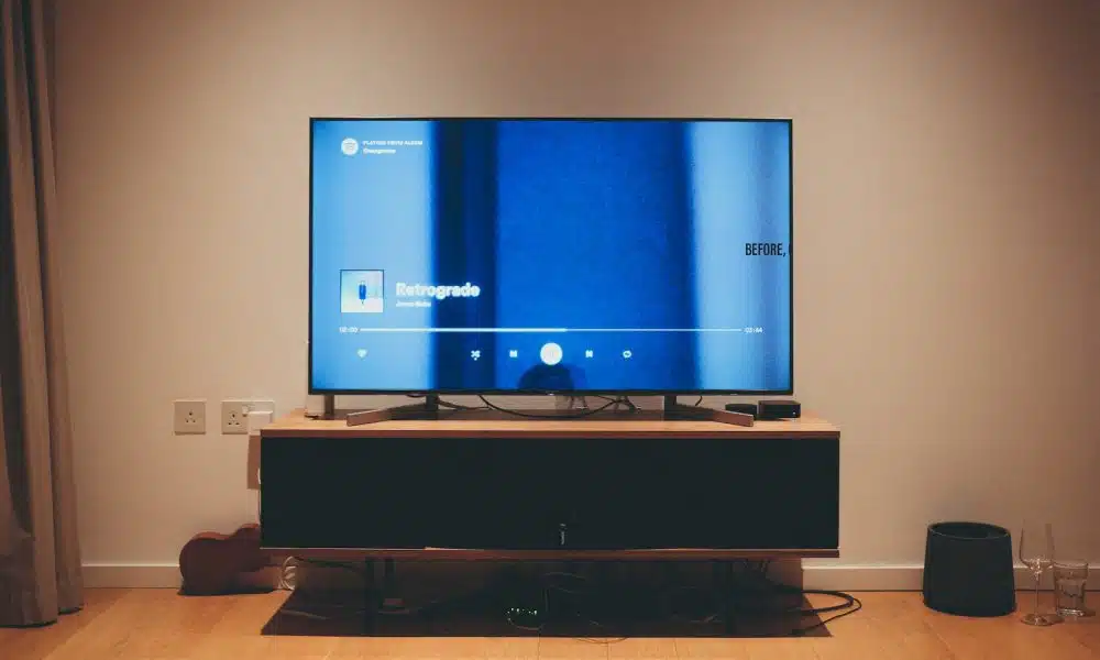 black flat screen tv on brown wooden tv rack