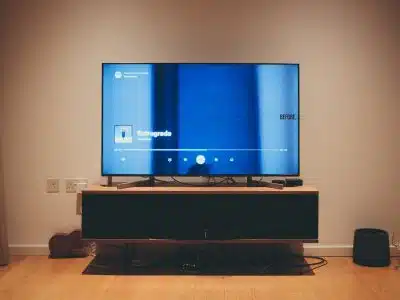 black flat screen tv on brown wooden tv rack