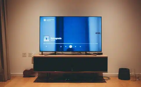 black flat screen tv on brown wooden tv rack