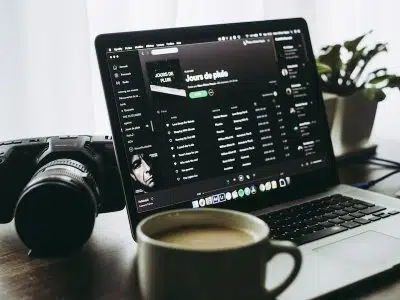 black and silver laptop computer beside white ceramic mug