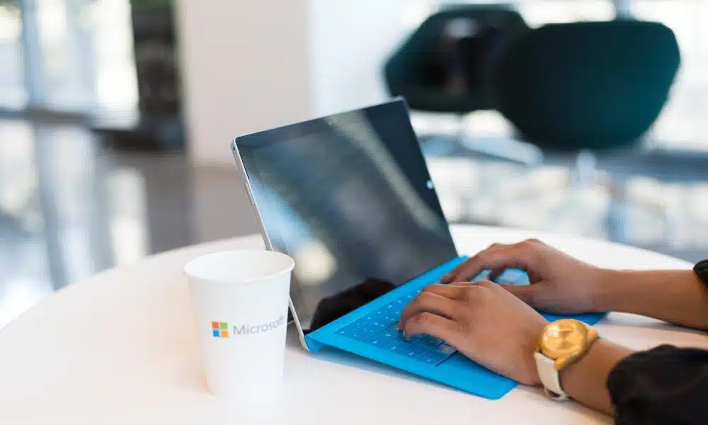 person using blue Microsoft Surface