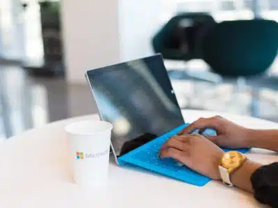 person using blue Microsoft Surface